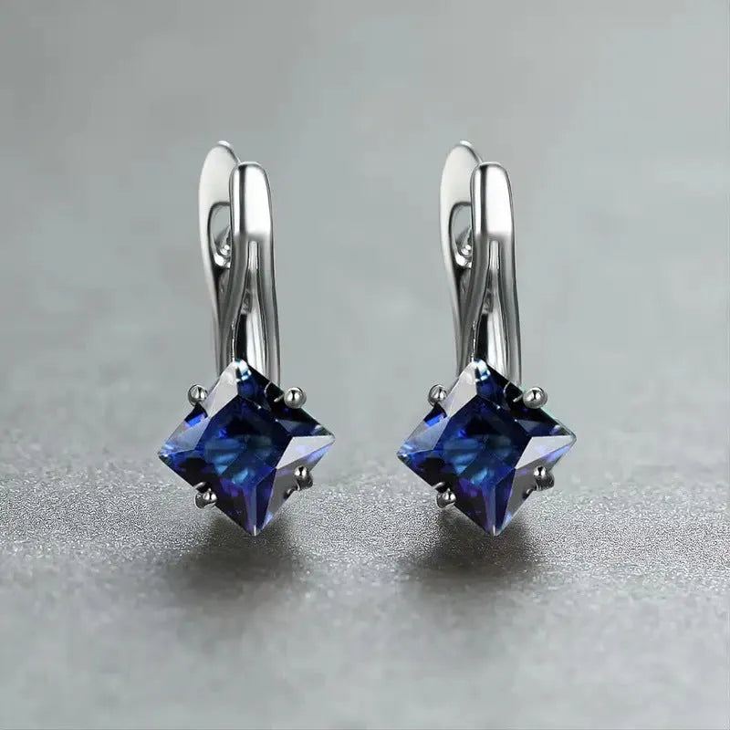 Women's copper earrings with diamond design and inlaid blue zircon stone.