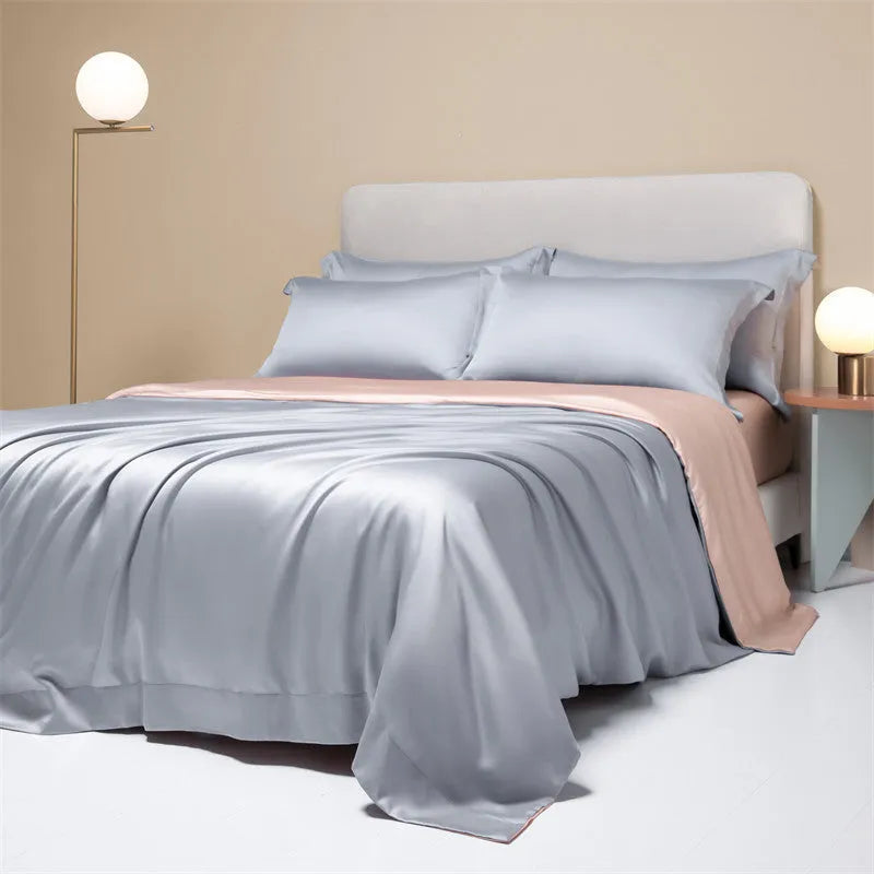 A modern, neatly made bed with a Lenzing Tencel duvet cover and pillowcases in a choice of nine colours like Sea Salt Blue.