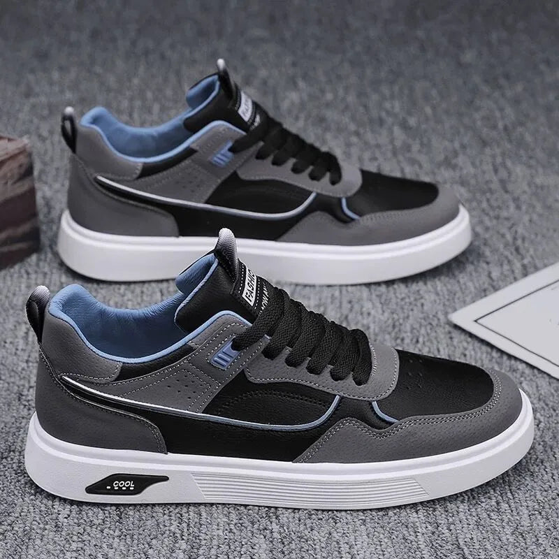 Men's beige low-top canvas board shoes with leather stitching details on a white background.