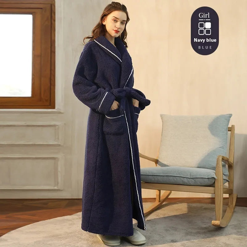A man and woman wearing matching navy blue thick flannel bathrobes, showcasing the wrap-around design and plush fabric.