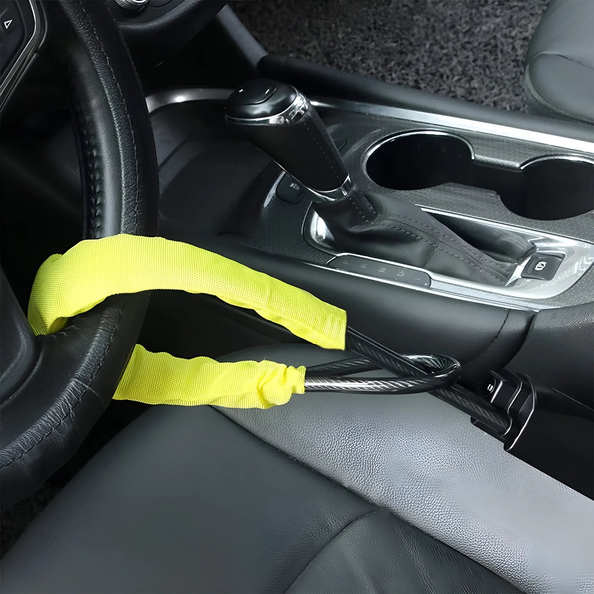 Red iron car steering wheel lock for General Motors vehicles on a steering wheel.
