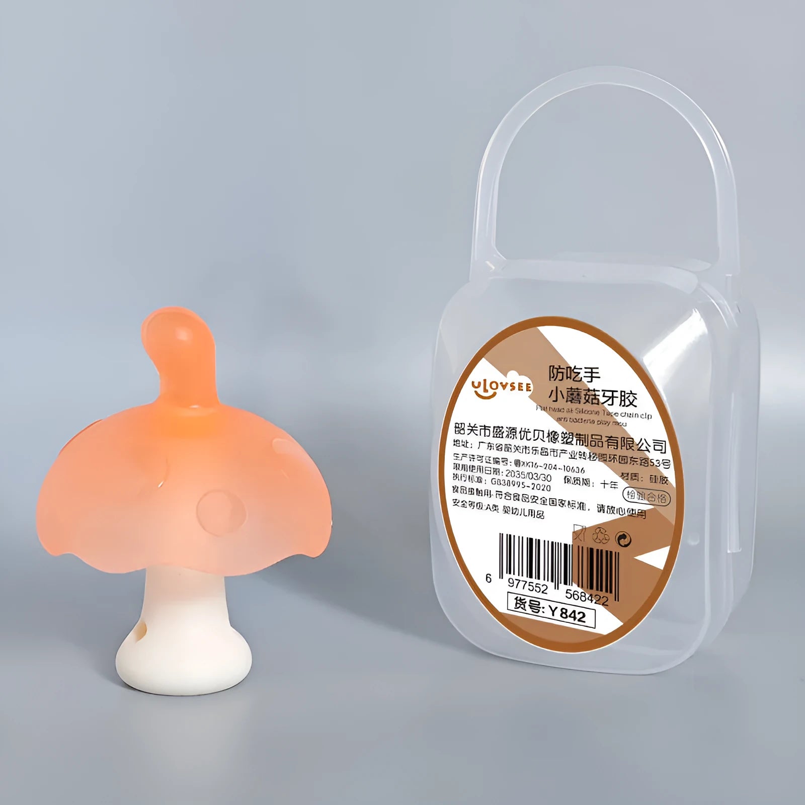 Small pink mushroom-shaped latex chewing gum in a transparent box with a chain.