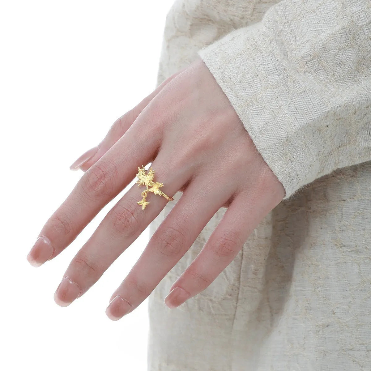 Silver butterfly ring with adjustable opening and electroplated gold finish options.
