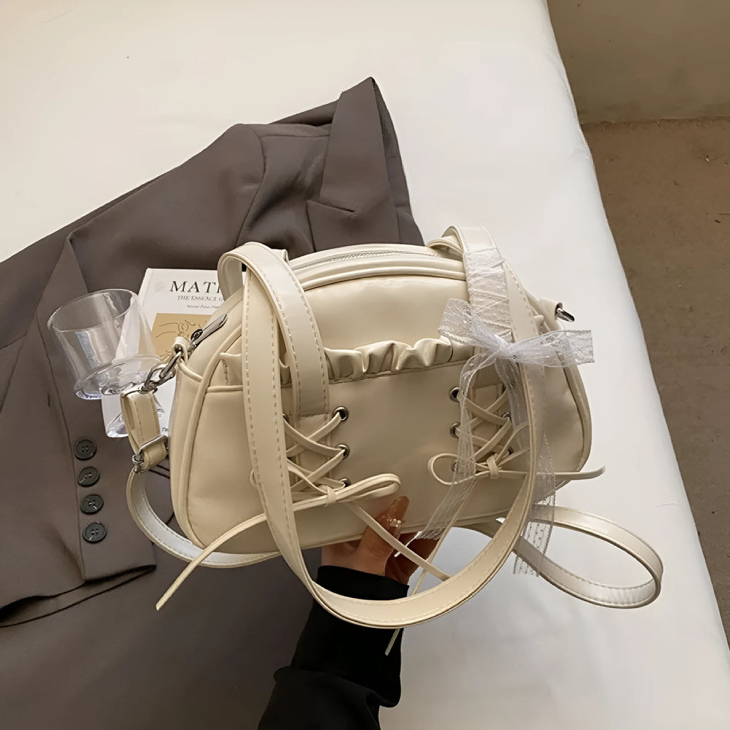 Women's bandage bow handbag in PU leather with shoulder strap and sewing thread detail