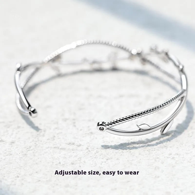 Twisted branch sprout bracelet in white gold finish with detailed copper construction