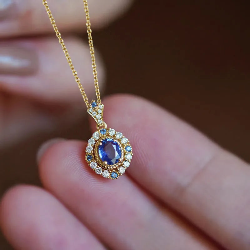 Huitan yellow gold necklace with adjustable chain and sparkling inlaid zircon gem pendant on a model.