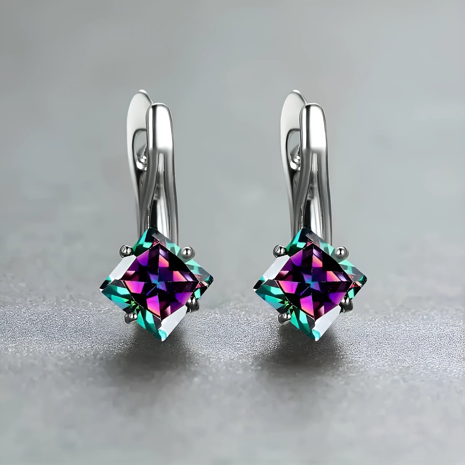 Women's copper earrings with diamond design and inlaid blue zircon stone.