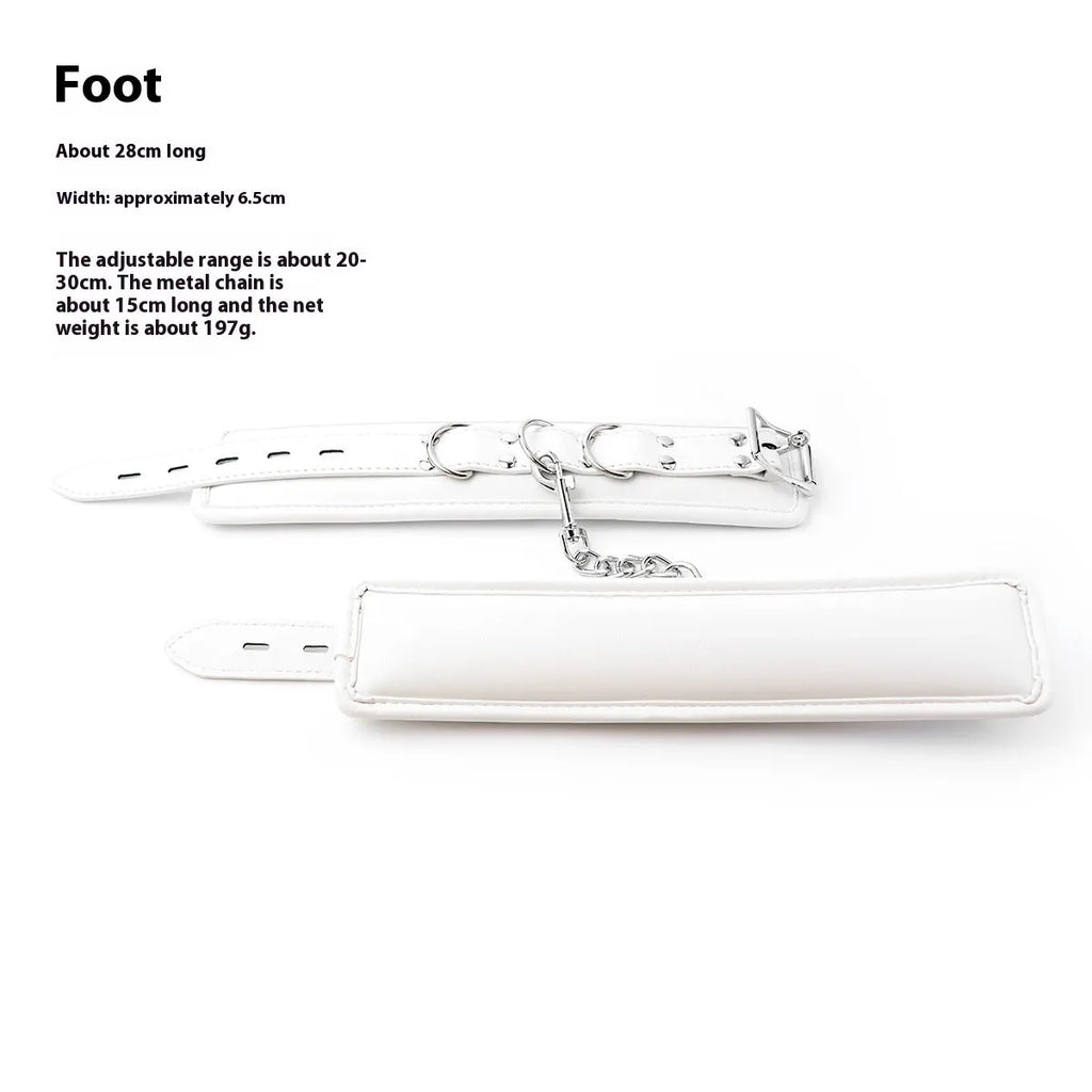 White PU sponge bondage set showing handcuffs, foot cuffs, and a neck scarf arranged together.