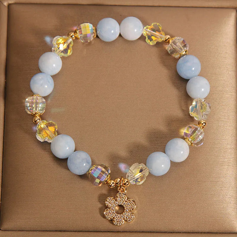 Aquamarine crystal bracelet with a four-leaf clover charm and pearl details for women.