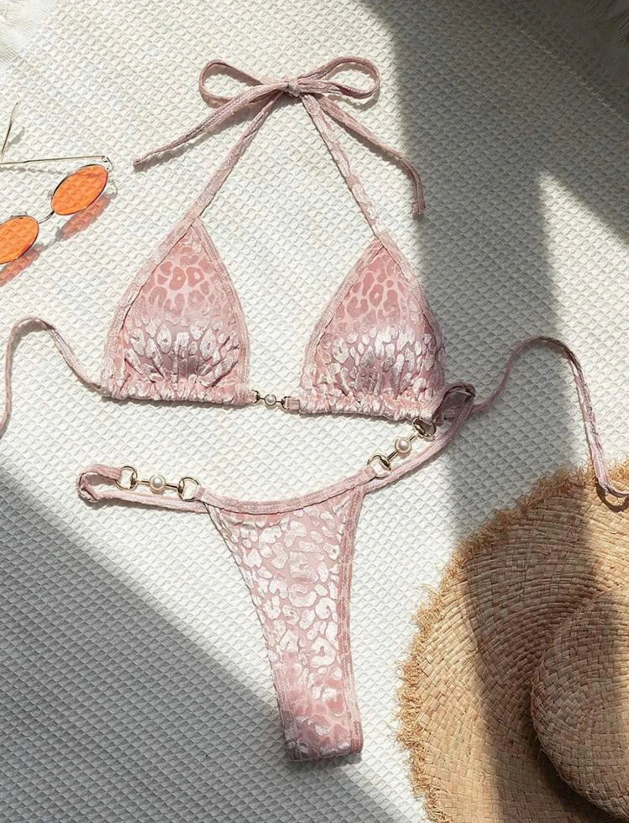 Women's T-shaped leopard print bikini swimsuit in polyester and spandex fabric on a mannequin.