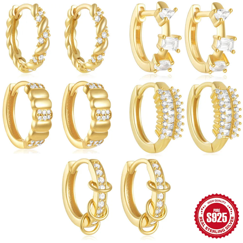 Sterling silver geometric stud earrings with small round diamond-like accents in gold and silver finishes.