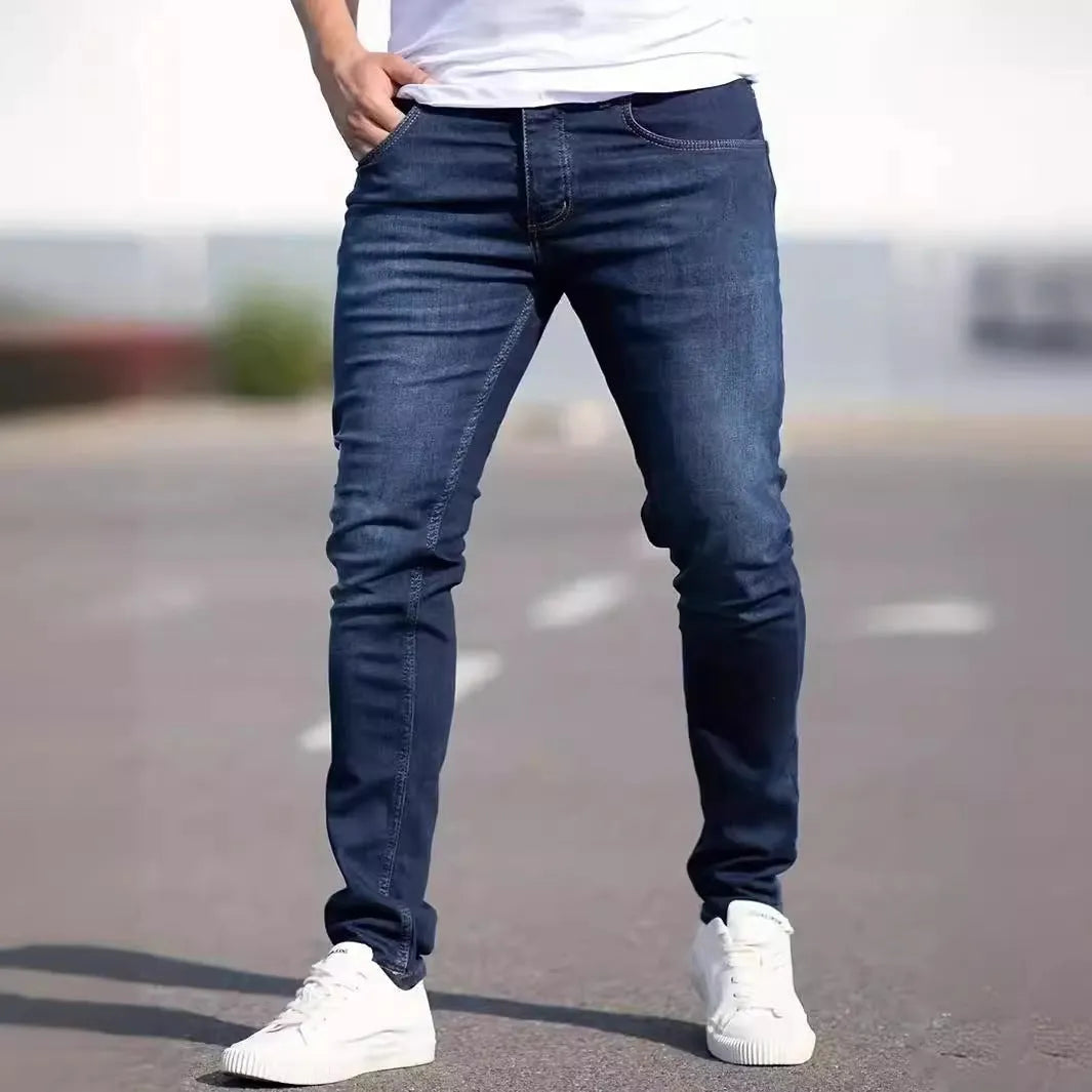 Men's dark blue slim fit skinny jeans on a hanger, showing mid waist and zipper fly detail.