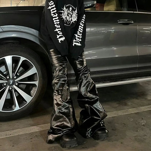 A pair of black skinny jeans with a high-shine patent leather finish and straight leg cut.