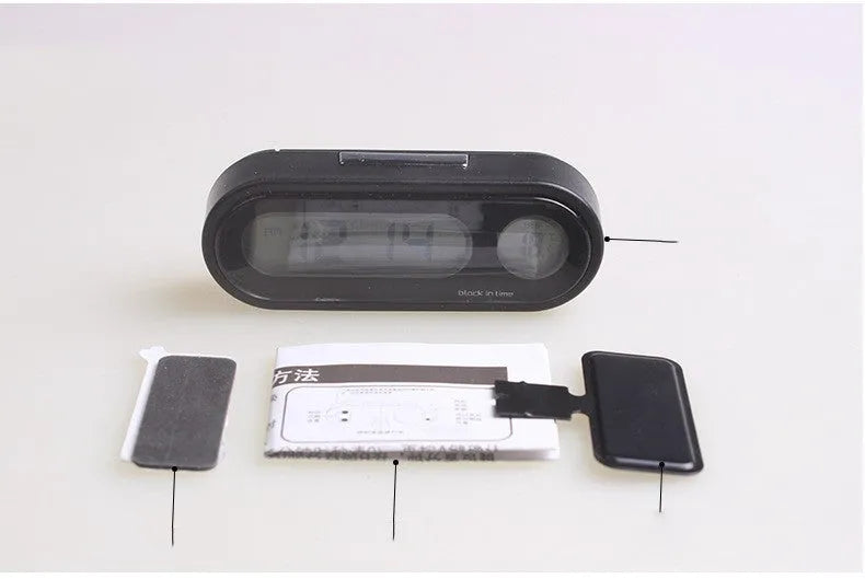 Black electronic car clock and thermometer with LED display on an adjustable bracket.