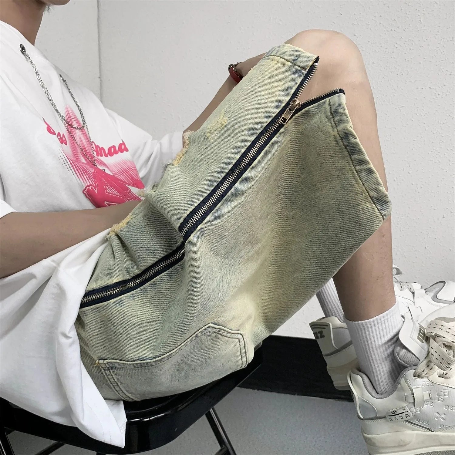 Men's blue retro denim shorts with five-point ripped distressing and yellow mud wash finish