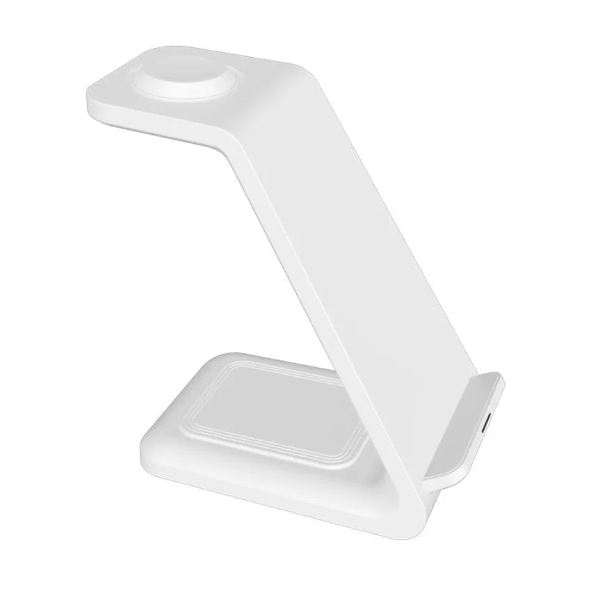White 3-in-1 wireless charging stand holding a mobile phone, smartwatch, and earbuds on a wooden desk.