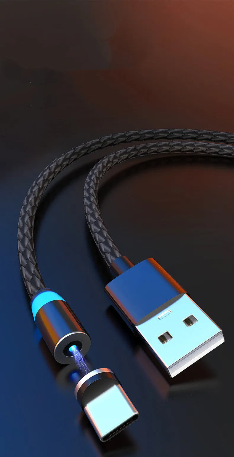Magnetic charging cable with glowing LED light connected to a phone, showing black and silver colour options on a desk.