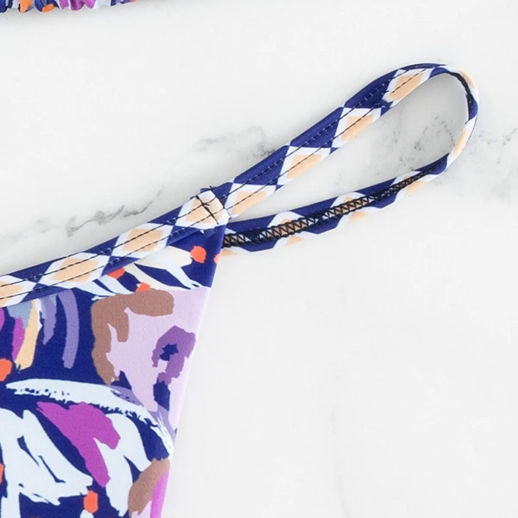 Women's floral print triangle bikini swimsuit with adjustable tie sides on white background