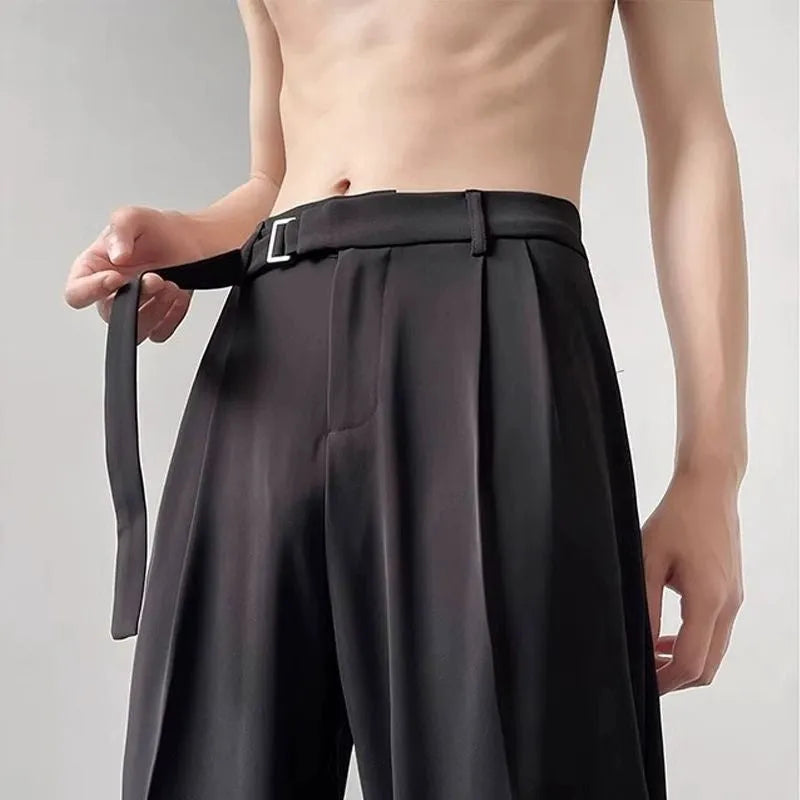 Model wearing thin black straight wide leg casual trousers with a loose fit.