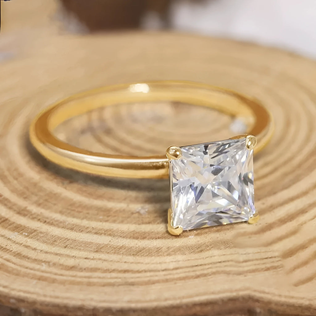 A simple geometric sterling silver ring with a round zirconia stone, shown in silver, gold, and rose gold finishes.