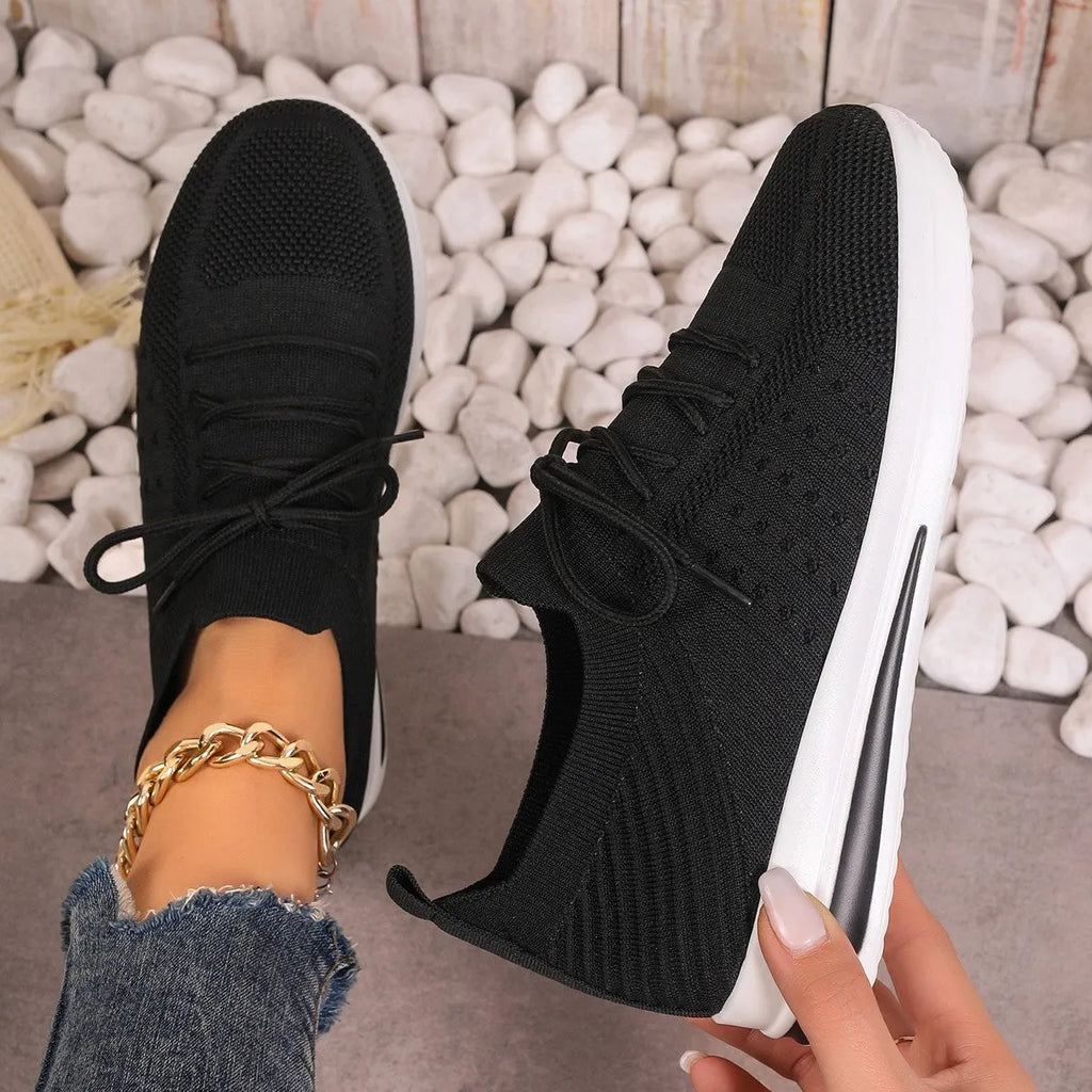 Women's low-top lace-up casual sneakers in red, black, and blue with a fly-knit pattern and round toe.