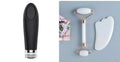 Natural white jade facial roller and gua sha scraper board set on a plain background.