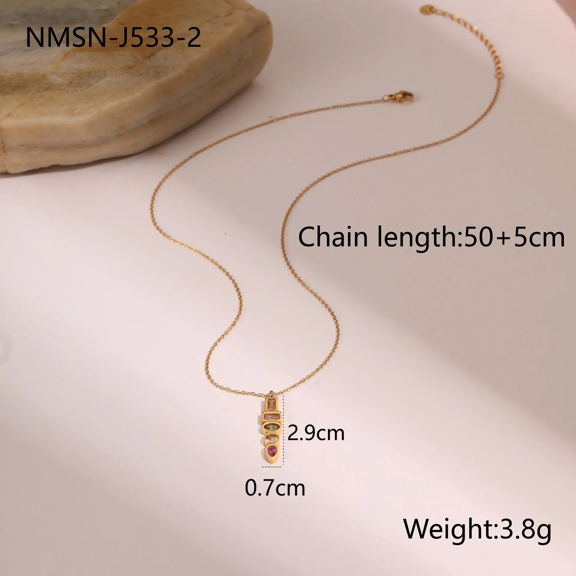 Geometric gold-plated jewellery set with colour zircon stones, showing necklace, ring, and earrings.