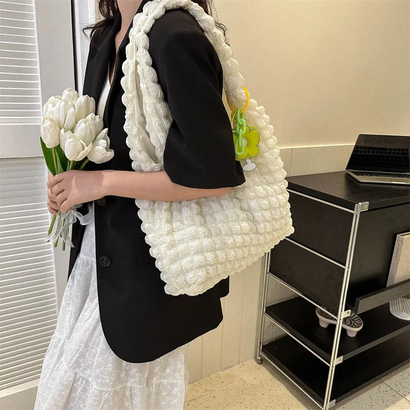 Women's soft pleated bubble shoulder bag in a vertical square shape with a detachable pendant charm.