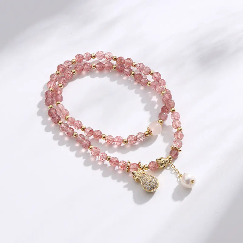 Women's strawberry quartz crystal bracelet with geometric shapes for money drawing