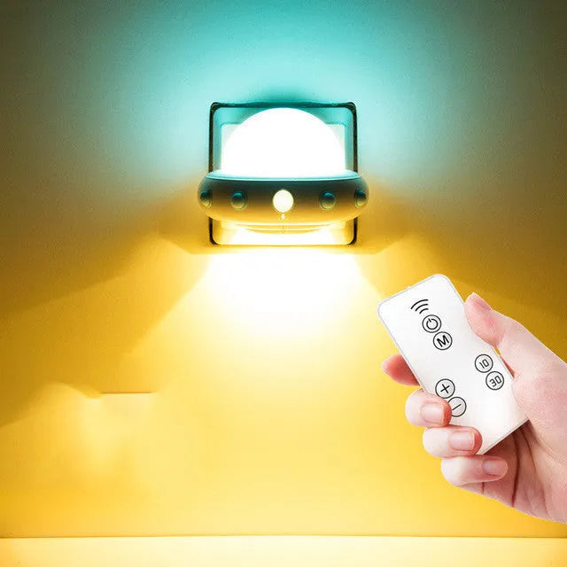 Remote control UFO-shaped bedside night light in blue, pink, or white with cartoon modern design