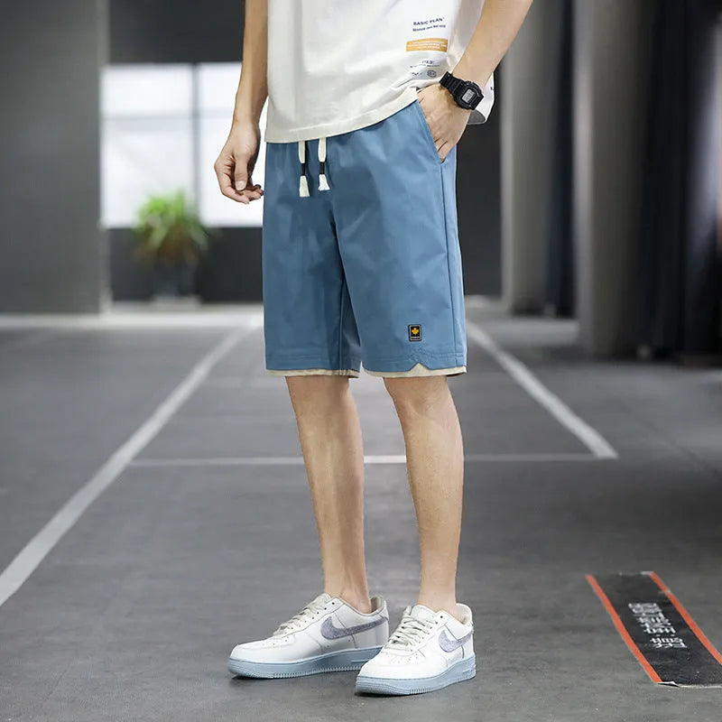 A pair of loose-fitting South Korea style beach shorts in a solid colour, showing the straight leg and casual cut.