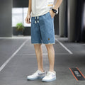 A pair of loose-fitting South Korea style beach shorts in a solid colour, showing the straight leg and casual cut.