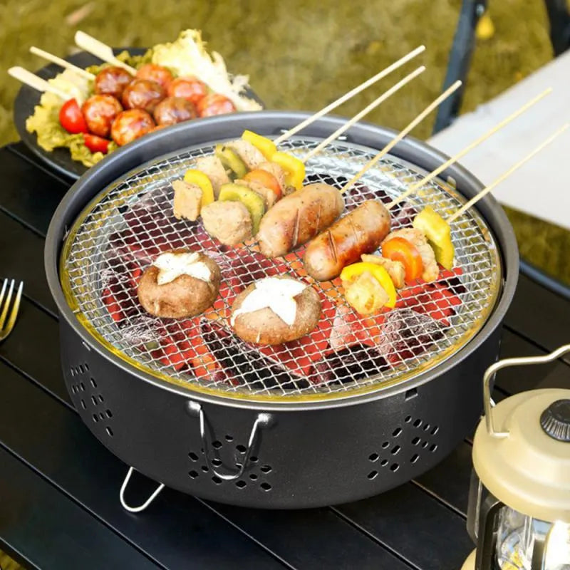 Portable stainless steel barbecue grill with detachable parts and storage bag for camping.
