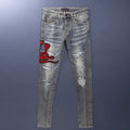 Old colour slim fit jeans with washed-out finish, patch details, and embroidery on cotton fabric.