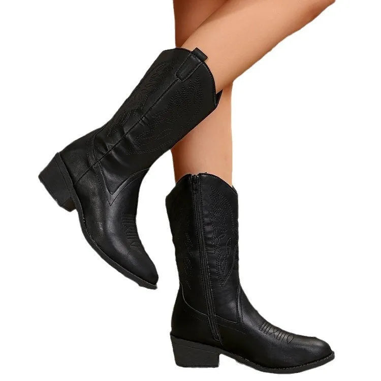 Women's black punk-style mid-calf boots with a chunky heel, pointed toe, and hollow-out details on the PU upper.