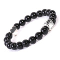 Tiger's Eye stone beaded bracelet with a geometric dog's paw design on a wrist.