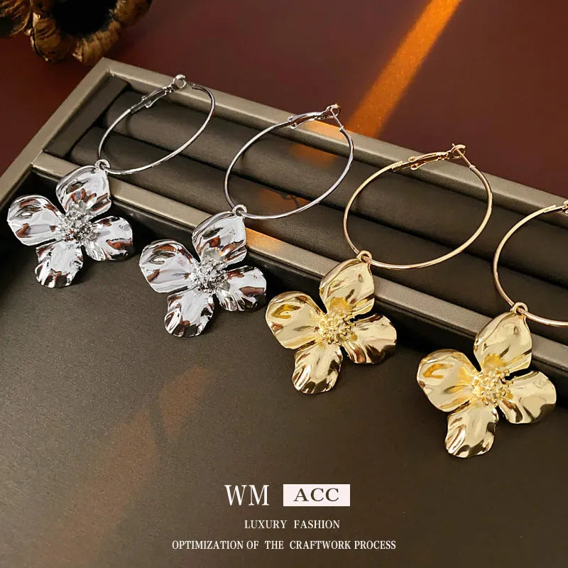 Gold and silver metal earrings with floral geometric design and electroplated finish
