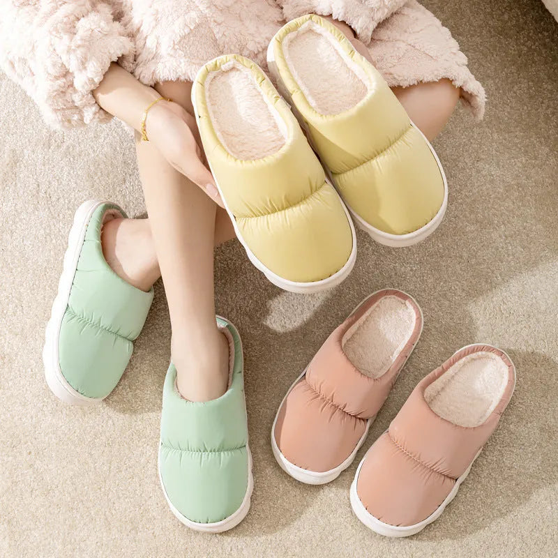 Pair of down cotton slippers with artificial leather upper and thick rubber sole, shown in available colours.