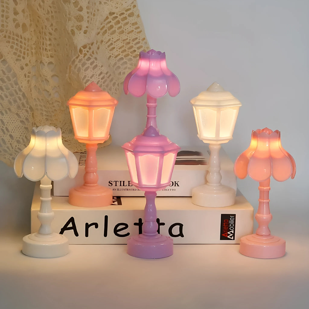 Small geometric retro pagoda night lamp in light purple, shown on a wooden surface.