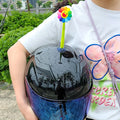 Yellow silicone sunflower helmet decoration with a black suction cup base attached to a helmet.