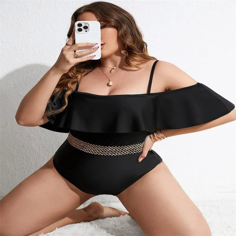 Black women's one-piece swimsuit on a hanger, plus size range 0XL to 4XL.