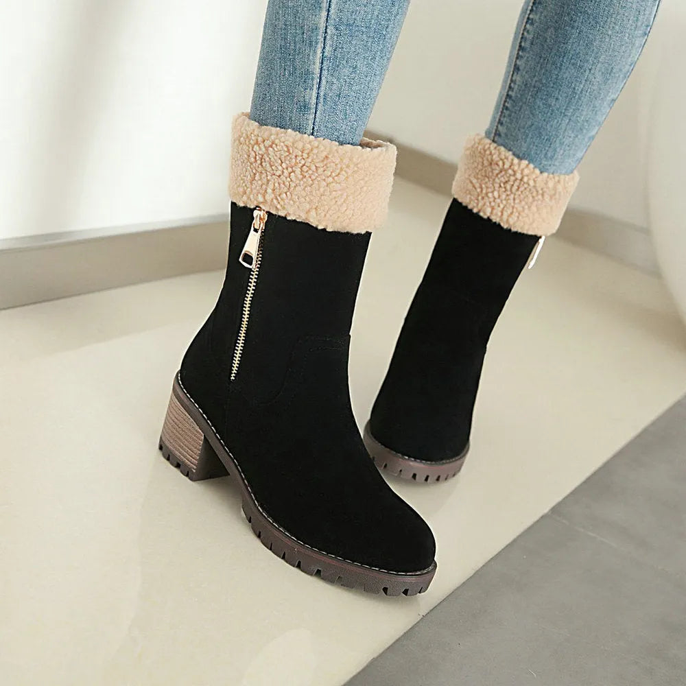A pair of ankle-height snow boots in black, shown with a short plush lining and rubber sole, on a white background.