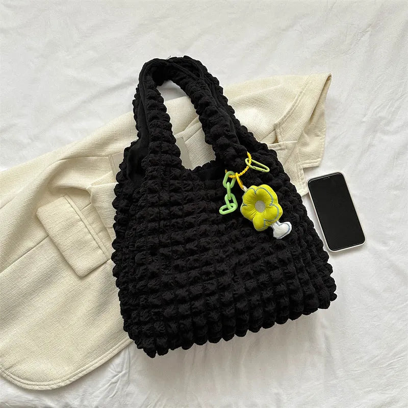 Women's soft pleated bubble shoulder bag in a vertical square shape with a detachable pendant charm.
