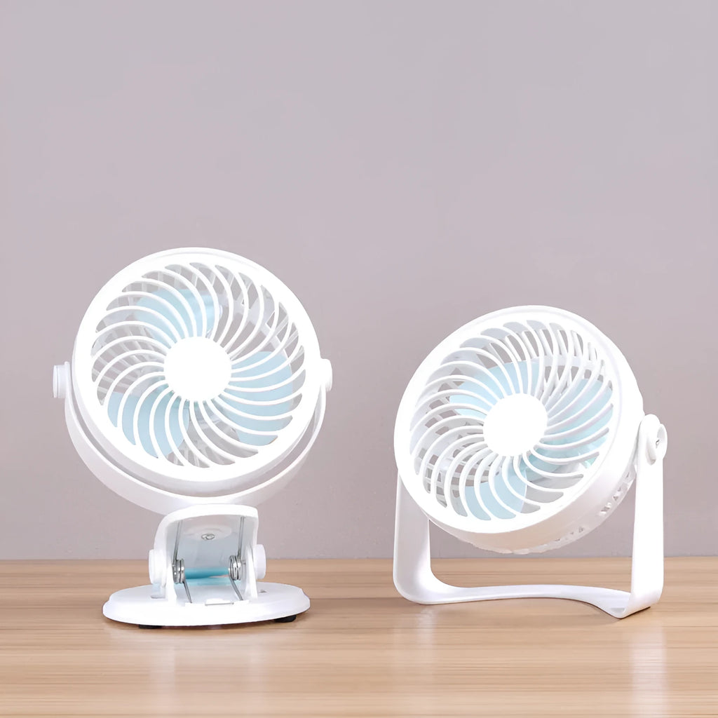 Small white USB desk fan with clip base and three blades on a wooden desk.