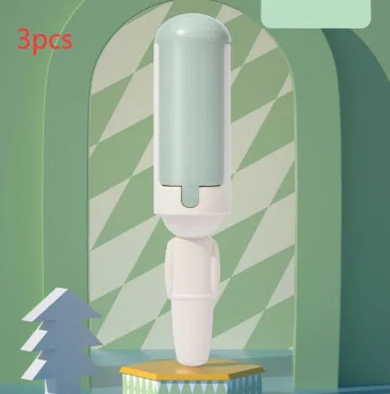 White and green pet hair removal roller with self-cleaning base on a carpet