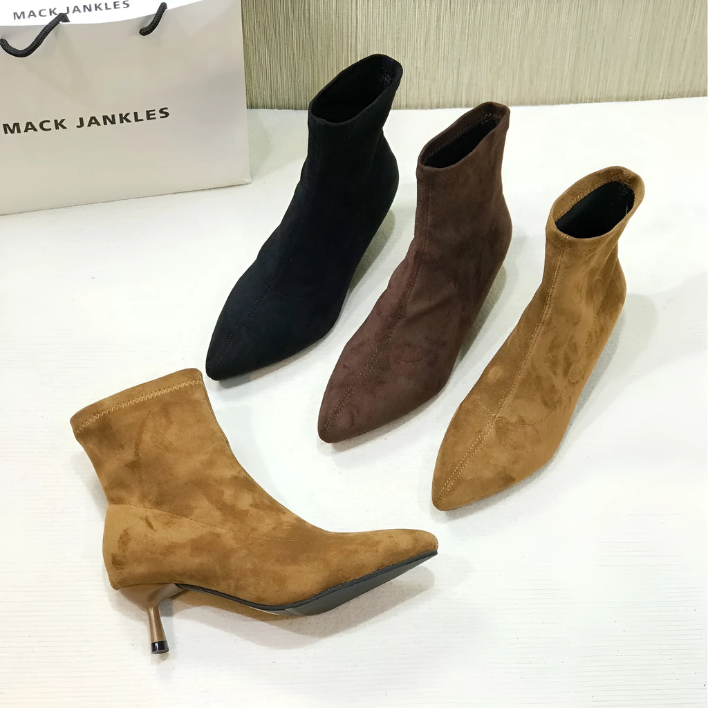 Black pointed toe women's ankle boots with a stiletto heel on a mid-calf shaft.