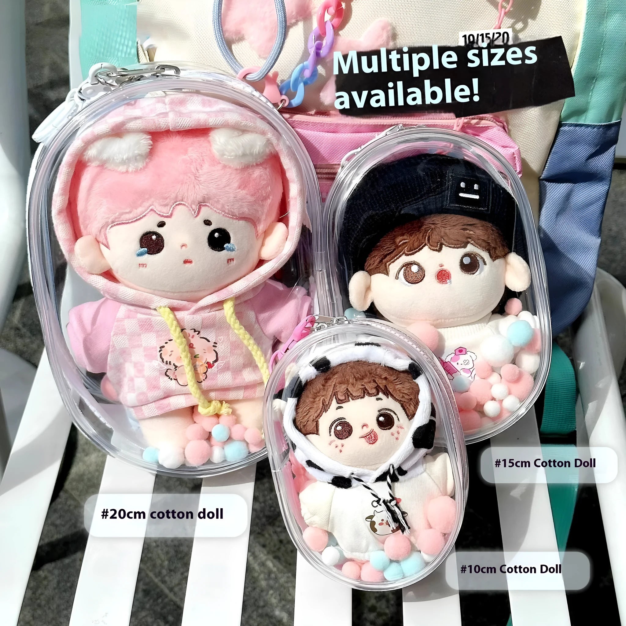 Transparent PVC cube-shaped storage bag with colourful ball keychain for doll drying and organisation.