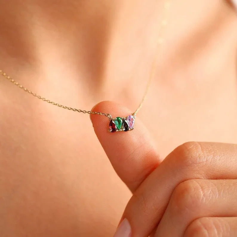 Zircon gemstone clavicle chain necklace in titanium steel, shown in gold, rose gold, and silver finishes.