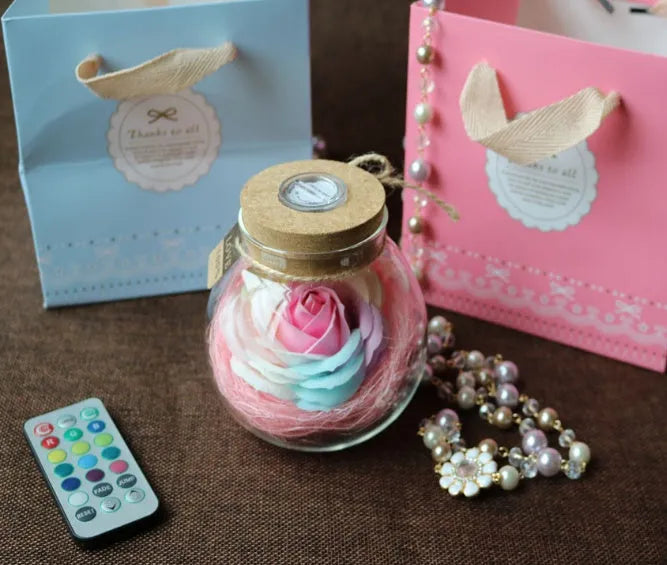 Colorful rose soap flower in glass wishing bottle with four colour options for decor or gift