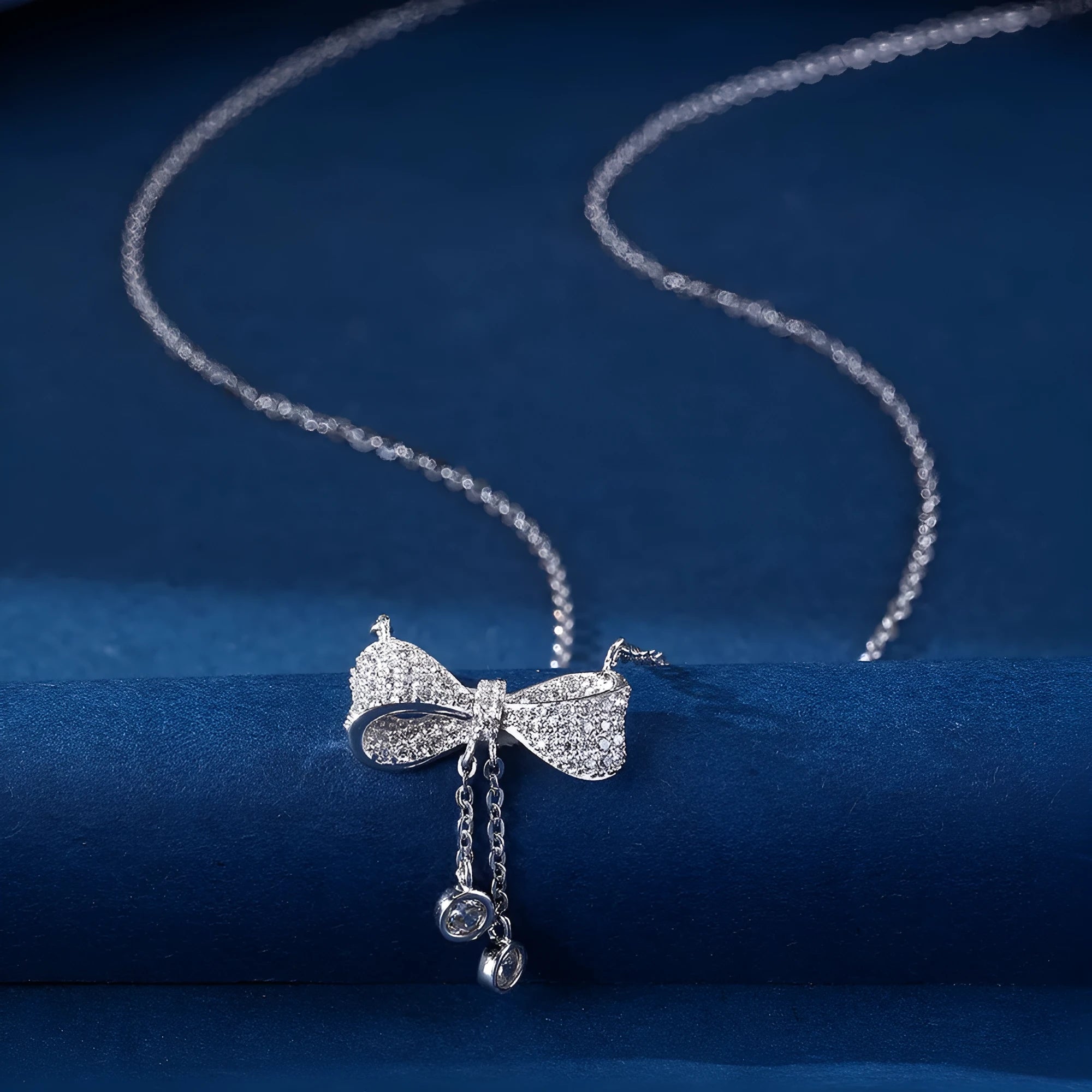 S925 sterling silver necklace with a bow pendant on an adjustable O-ring chain.